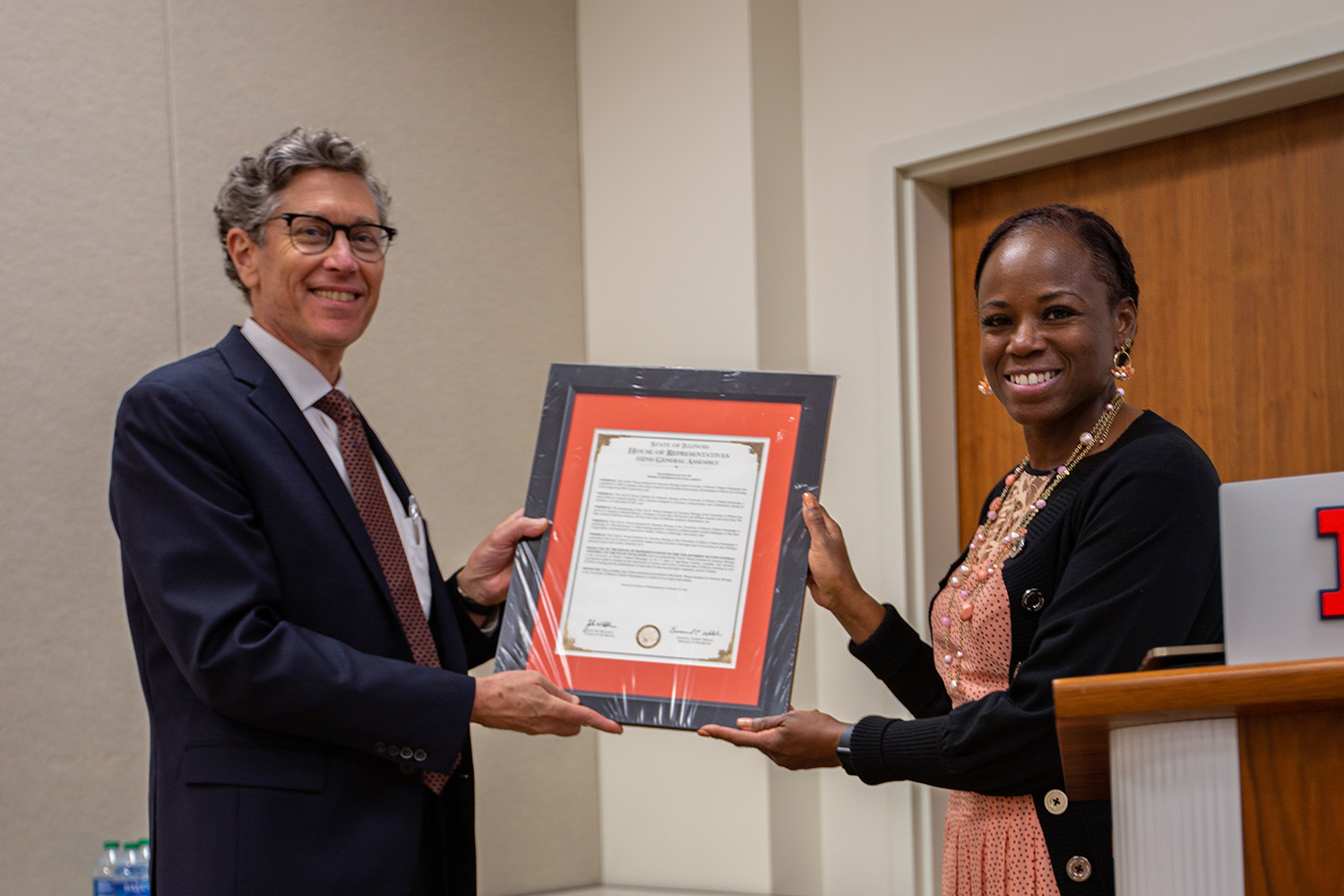 State Representative Carol Ammons (right) presented Gene Robinson a copy of House Resolution 0690.