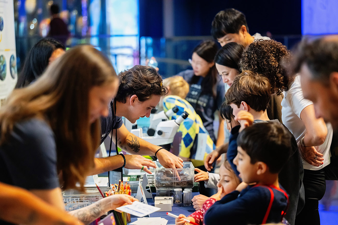 People interacting with the Science and Society station