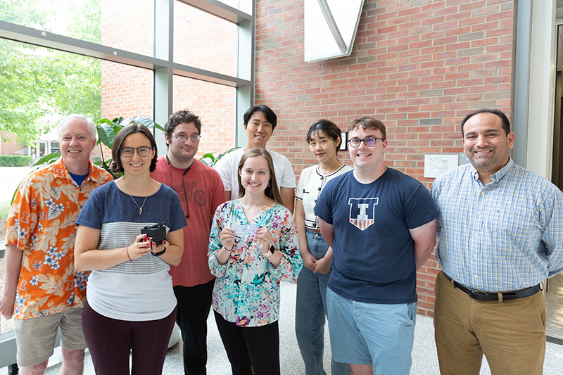 From left: Brian Cunningham, Amanda Bacon, Aaron Jankelow, Katherine Koprowski, Han Keun Lee, Weijing Wang, Robert Stavins, and Enrique Valera. Bacon and Koprowski are holding the instrument and the cartridge, respectively.