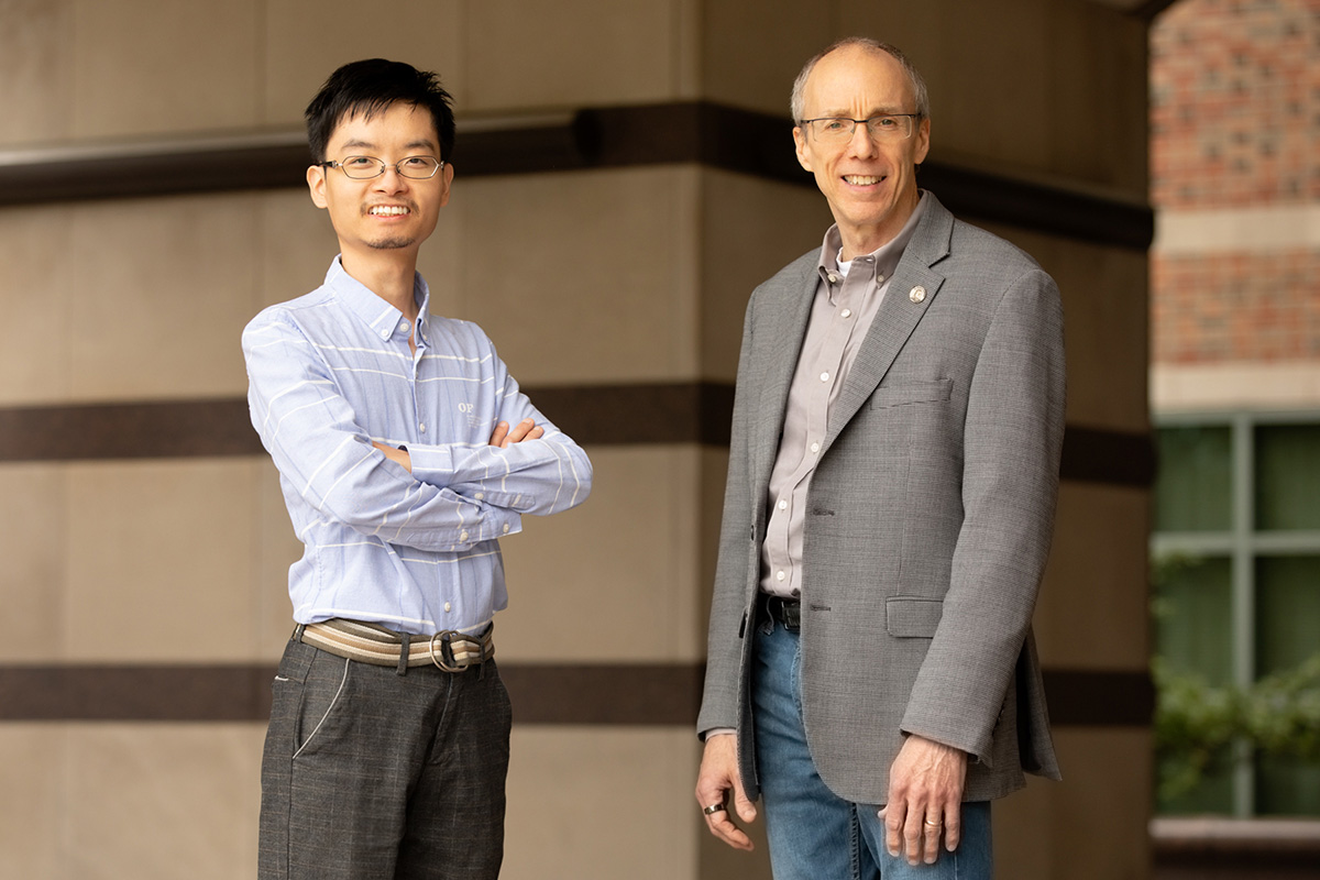 Researchers Yue Liu, left, and Jeffrey Moore are the first to use mechanical force to access unconventional chemical reaction pathways along potential energy surfaces. The new technique could help researchers produce fuels, fertilizers, pharmaceuticals and other materials more efficiently.