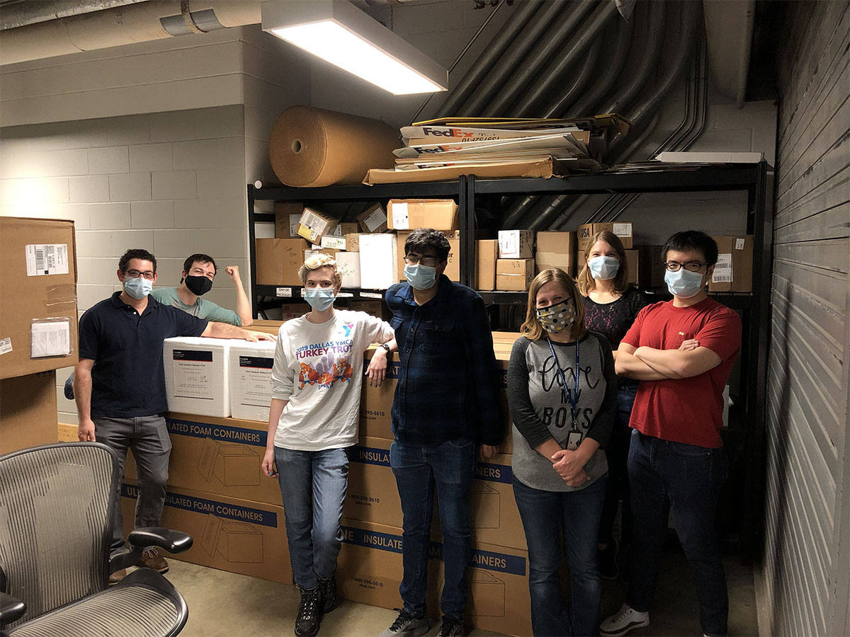 From left: Max Simon, Kyle Shelton, Laura Daigh, Auroni Gupta, Jana Radin, Katie Frye, and Xiaorui Guo stand next to a shipment of viral transfer media (VTM) prior to shipment. The group was among the almost 50 volunteers at Illinois who helped produce enough VTM for 200,000 COVID-19 tests.